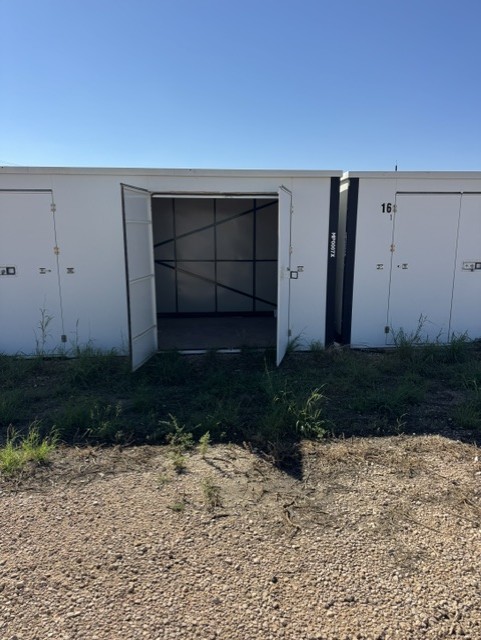 Enclosed storage unit with the door open at Lucky Star RV Park in Midland, TX