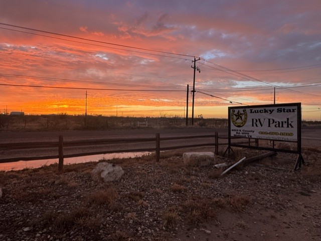 Lucky Star RV Park entrance sign on County Road 1270 in Midland, TX, at sunrise